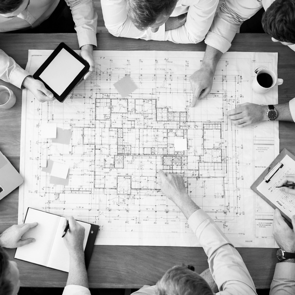 a team looking at a blueprint